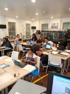 Young participants use laptops during a digital skills training session in Las Vegas.