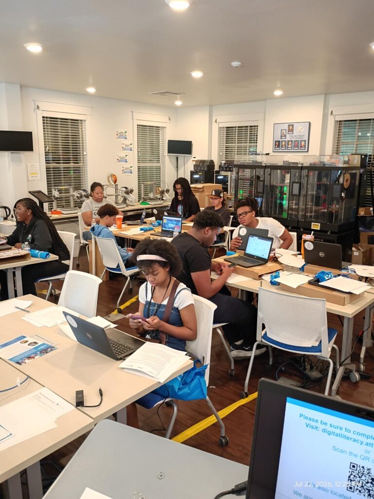 Young participants use laptops during a digital skills training session in Las Vegas.